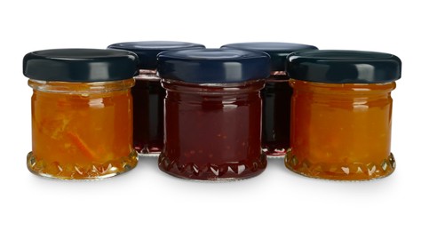 Jars with different jams on white background