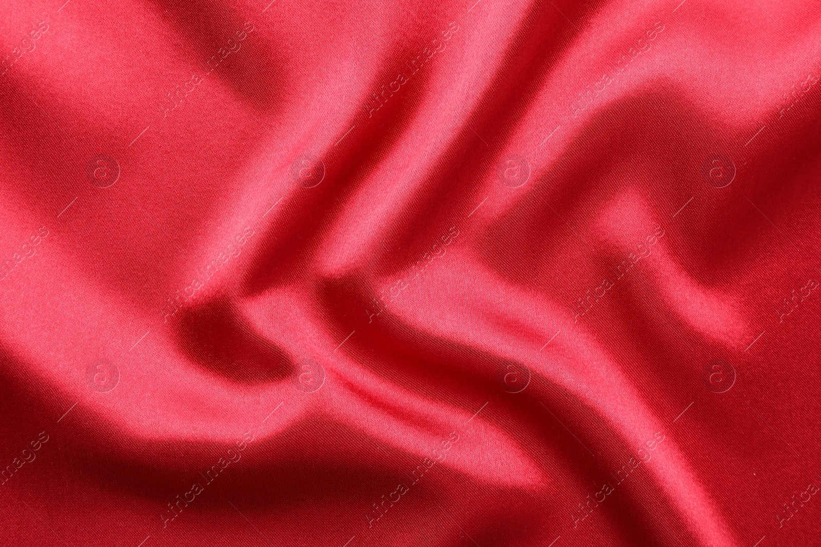 Photo of Texture of beautiful red silk fabric as background, closeup