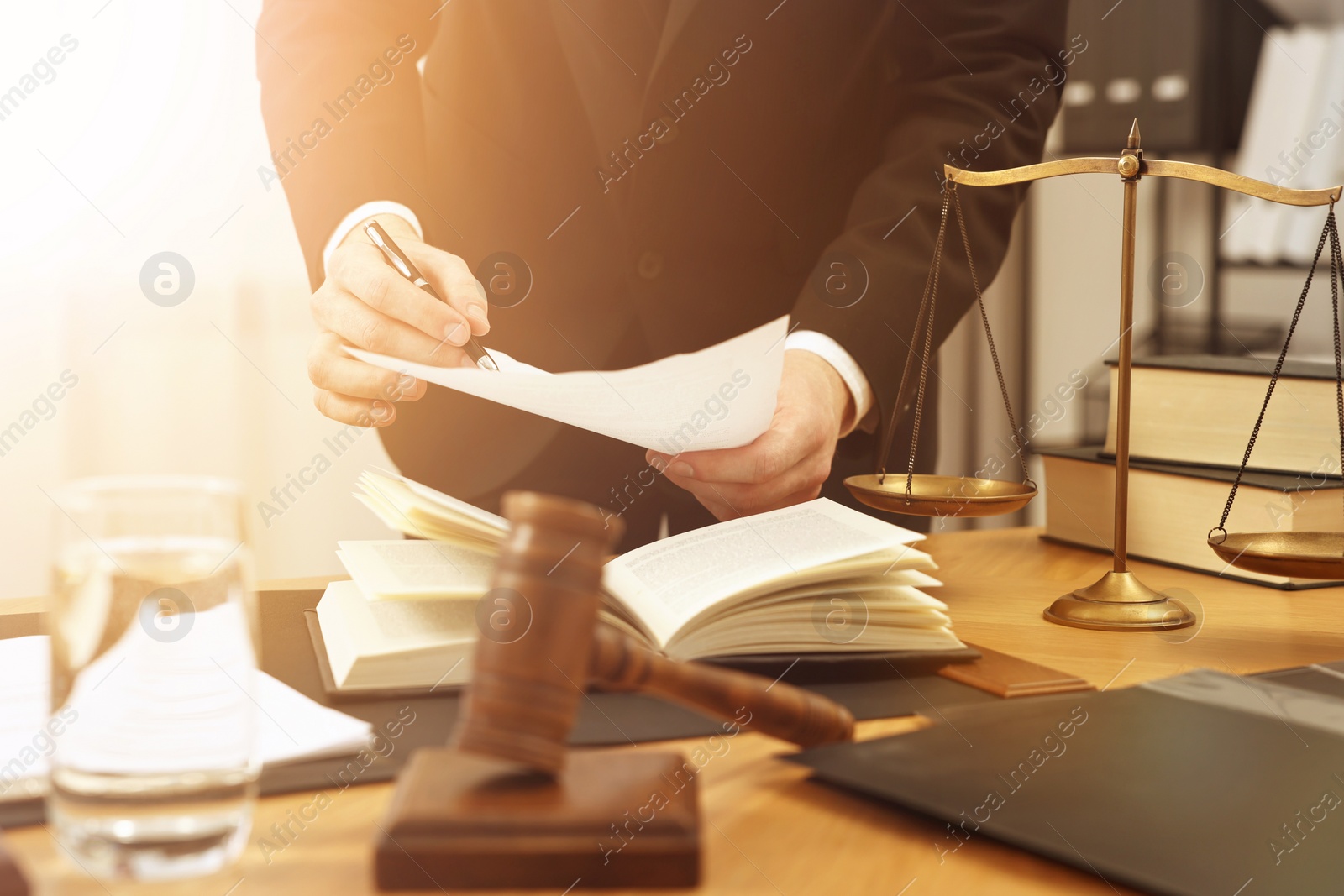 Image of Lawyer working with document at wooden table, closeup