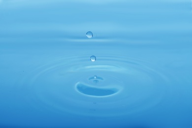 Splash of blue water with drop as background, closeup