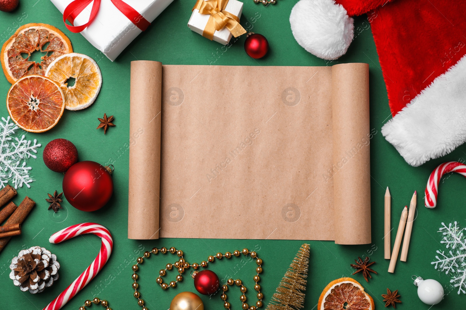 Photo of Flat lay composition with scroll and Christmas decor on color background. Letter for Santa Claus