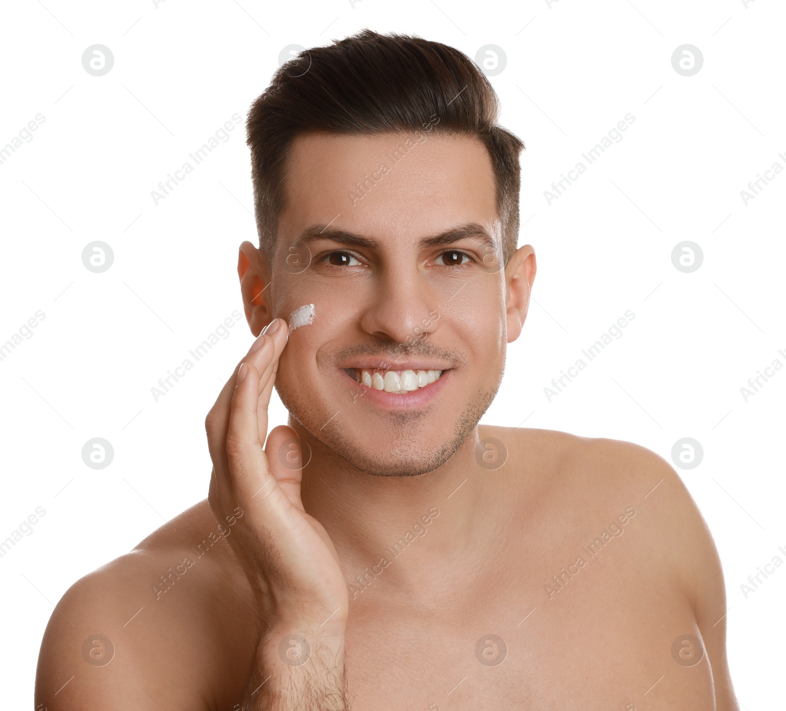 Photo of Handsome man applying face cream on white background