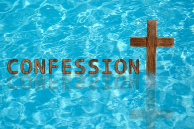 Image of Word Confession near wooden Christian cross in water