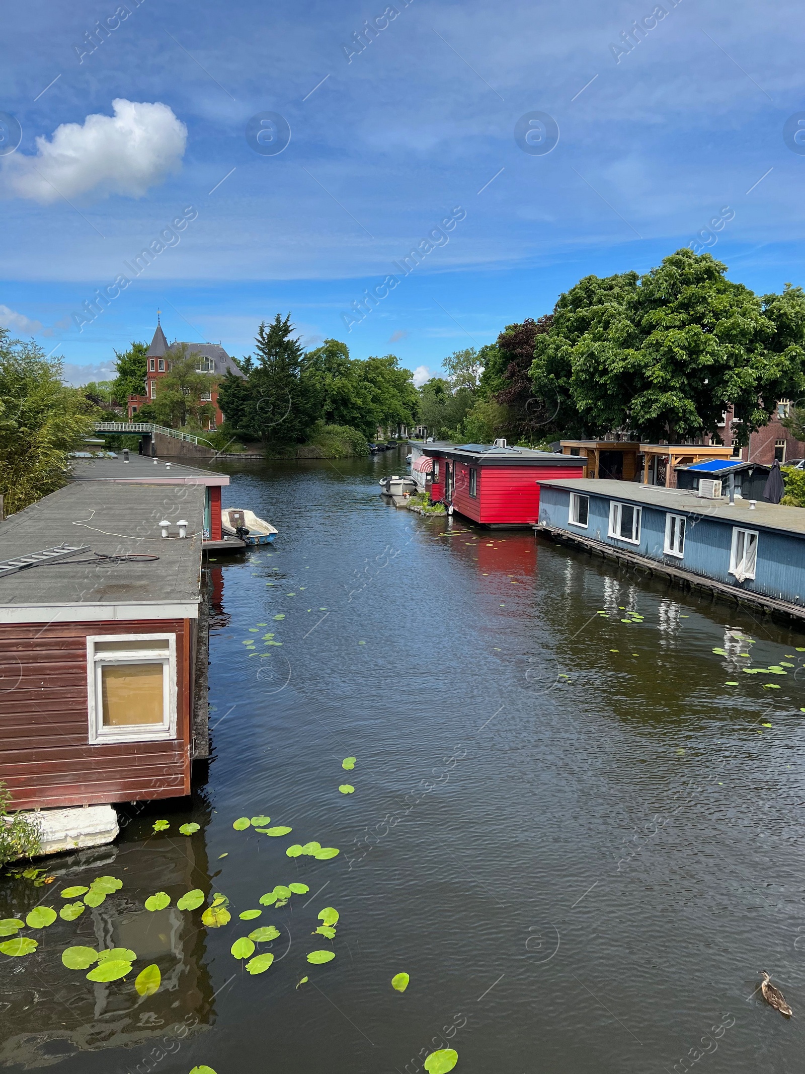 Photo of Beautiful view of canal with floating houses on sunny day