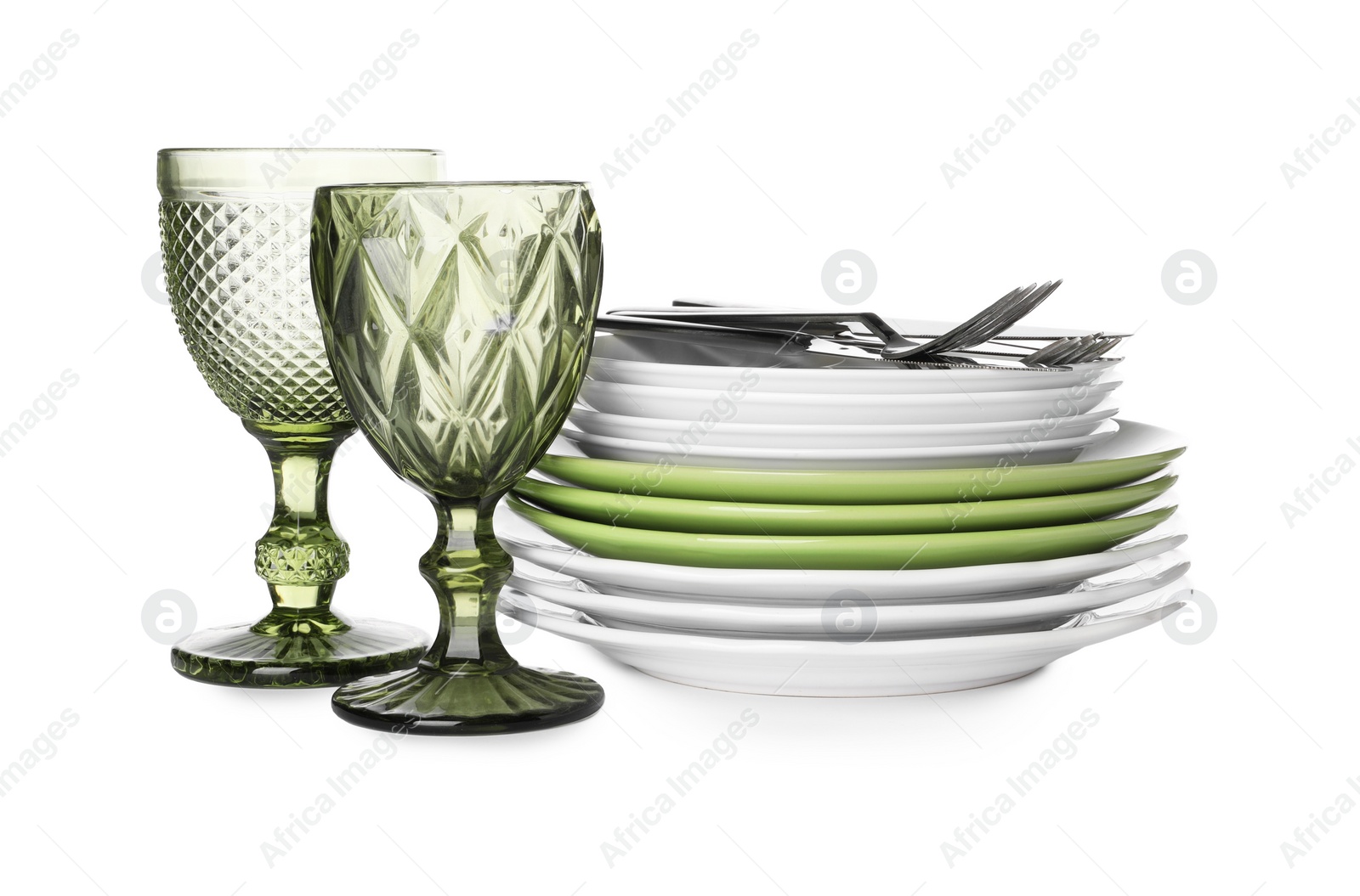 Photo of Set of beautiful ceramic plates, glasses and cutlery isolated on white