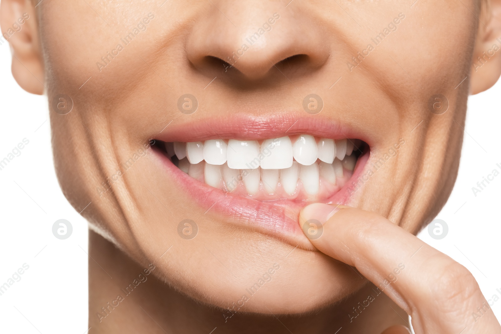 Photo of Woman showing healthy gums on white background, closeup