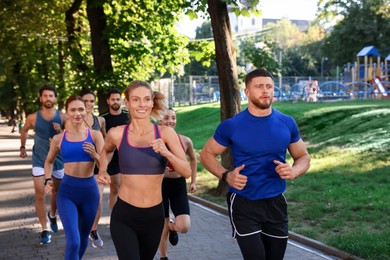 Photo of Group of people running in park. Active lifestyle