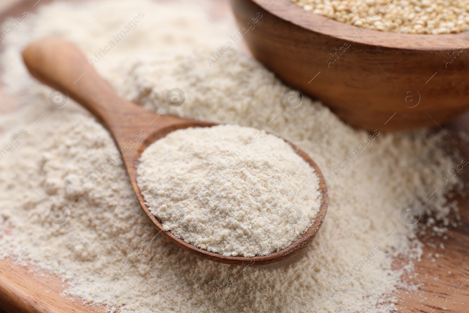 Photo of Wooden spoon with organic quinoa flour, closeup