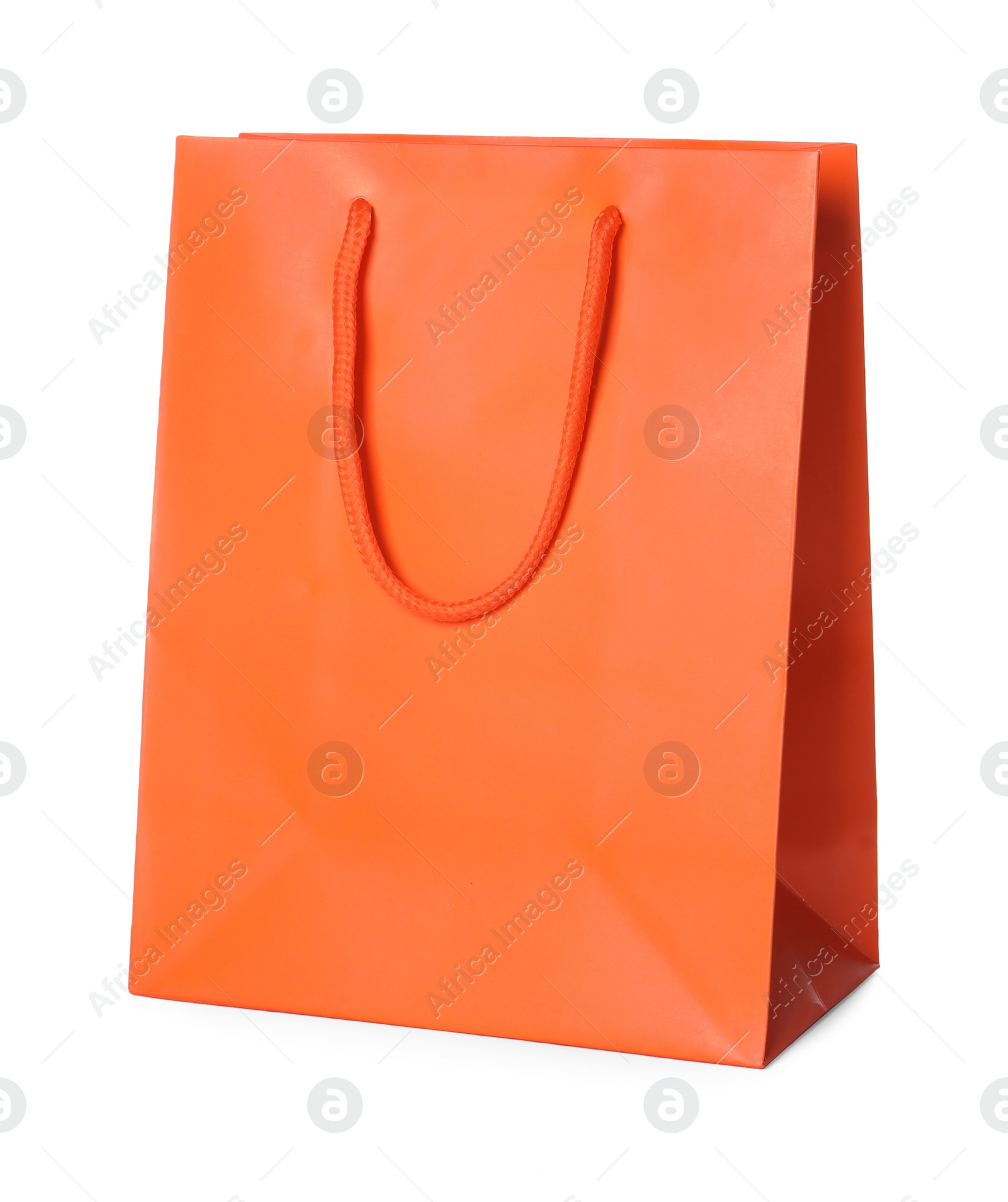 Photo of One orange shopping bag isolated on white