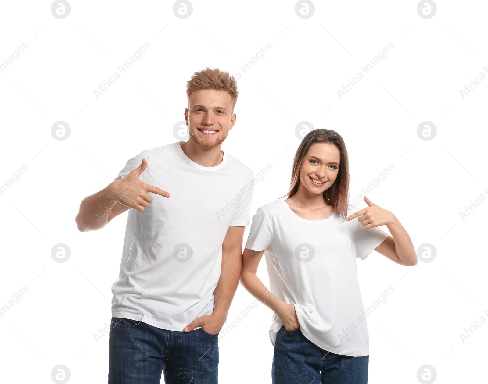 Photo of Young couple wearing blank t-shirts isolated on white. Mockup for design