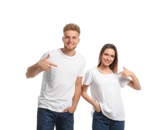 Young couple wearing blank t-shirts isolated on white. Mockup for design