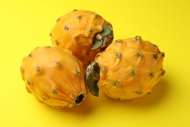 Photo of Delicious pitahaya fruits on yellow background, closeup