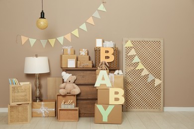 Photo of Gift boxes and toys in room decorated for baby shower party