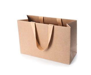 Paper shopping bag with comfortable handles on white background. Mockup for design