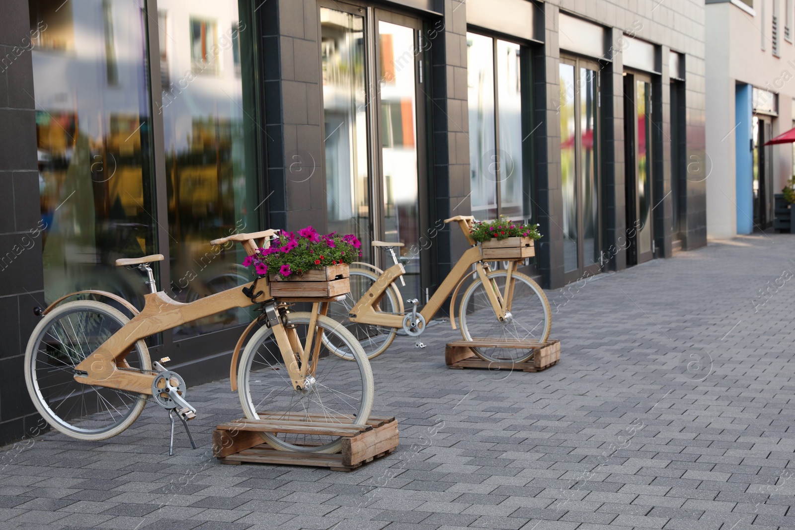 Photo of Bikes with beautiful flowers near building on city street