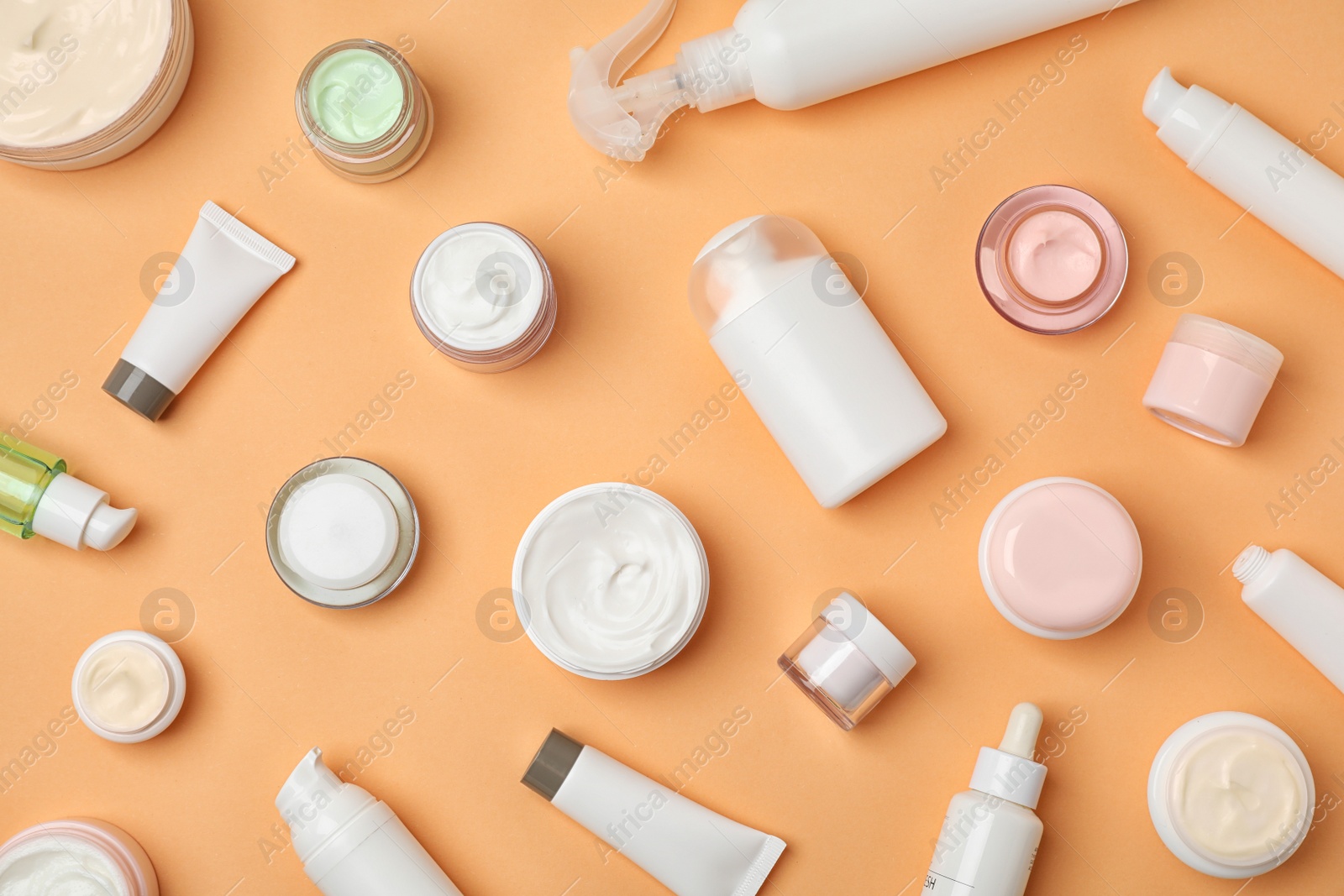 Photo of Flat lay composition with cosmetic products on color background