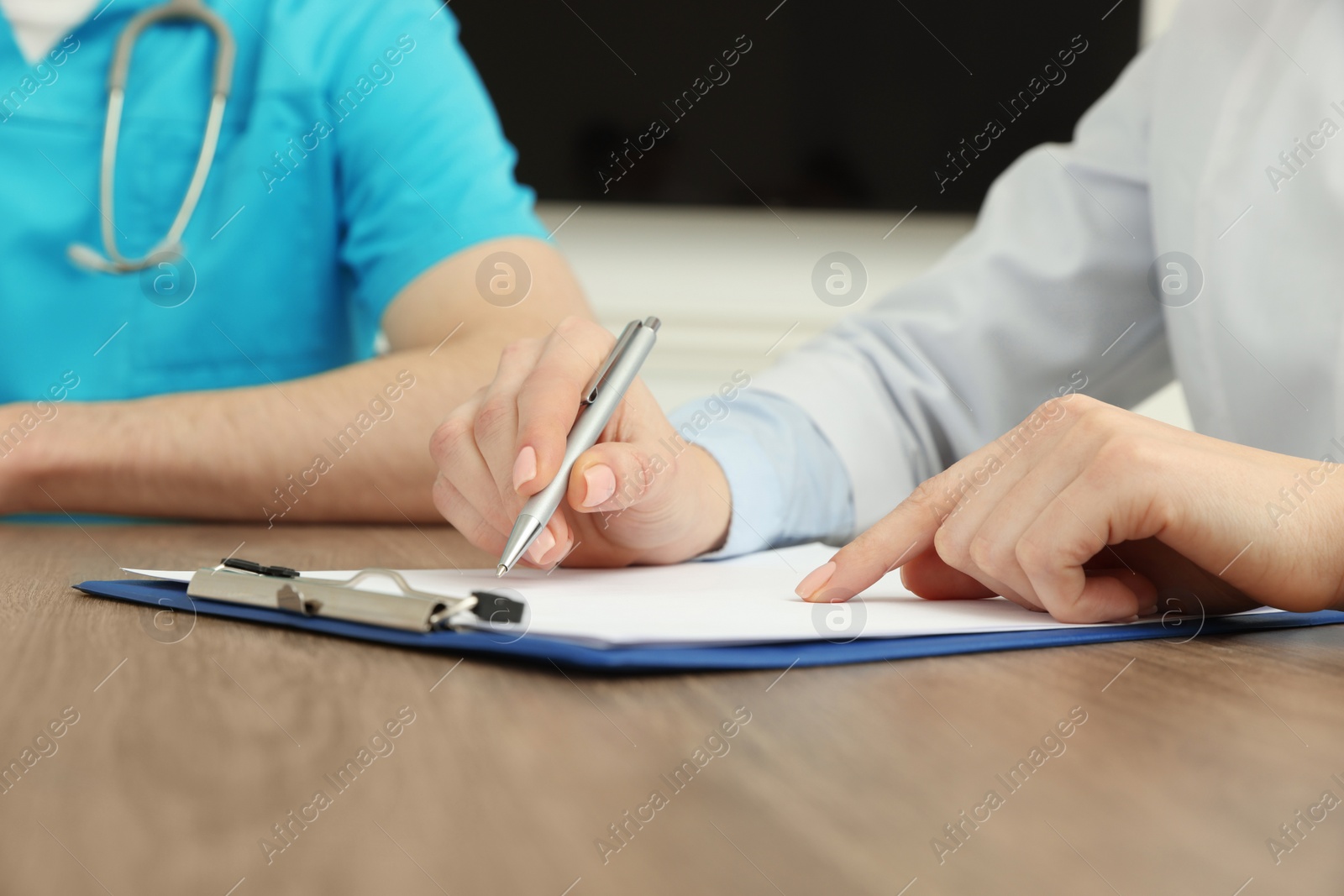 Photo of Medical conference. Doctors working at wooden table, closeup