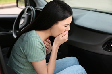 Photo of Young woman suffering from nausea in car