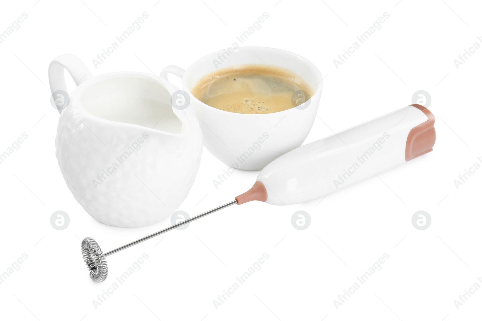 Photo of Mini mixer (milk frother), cup of coffee and pitcher isolated on white