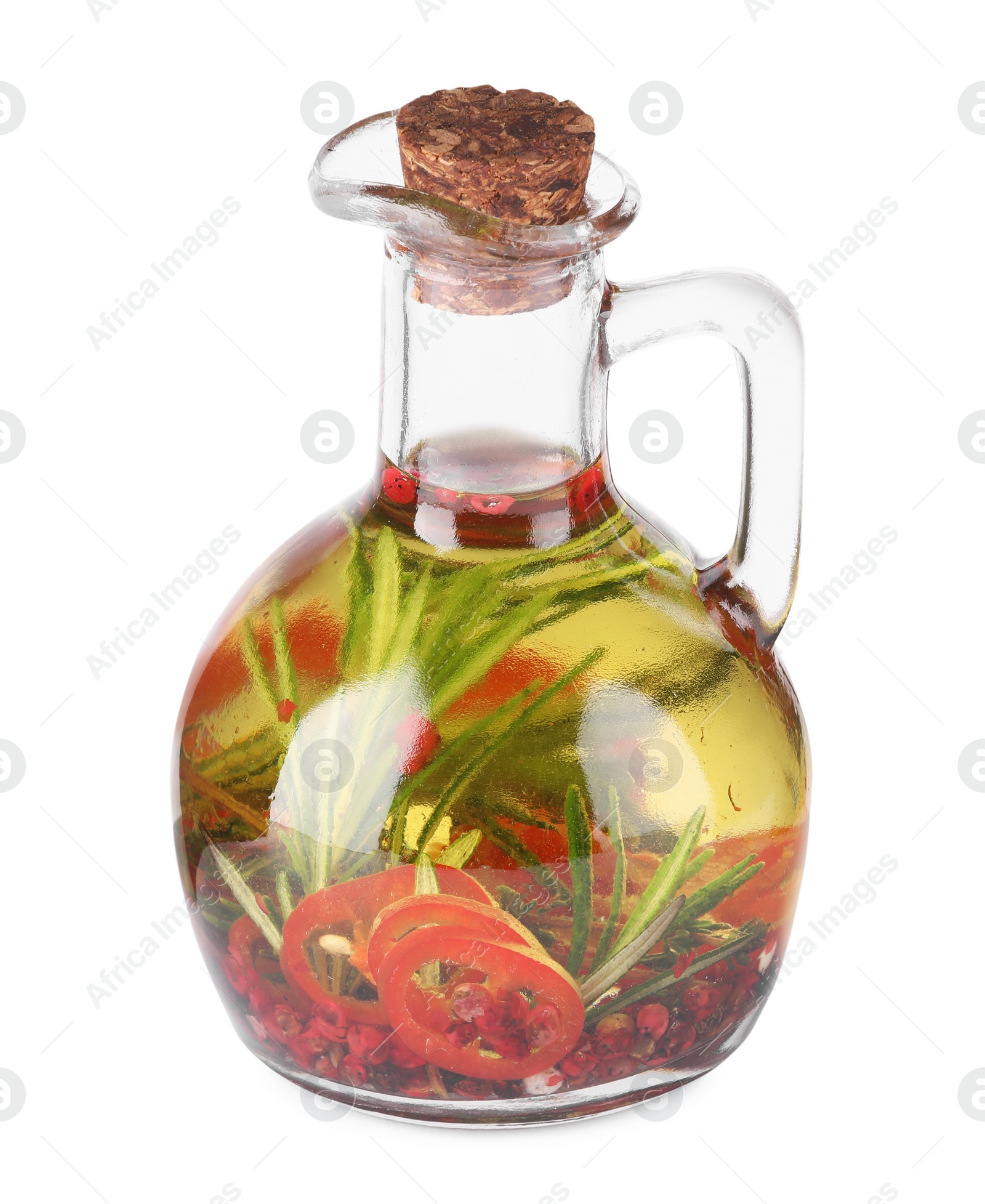 Photo of Glass jug of cooking oil with spices and herbs isolated on white