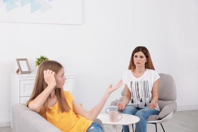 Mother scolding her teenager daughter at home