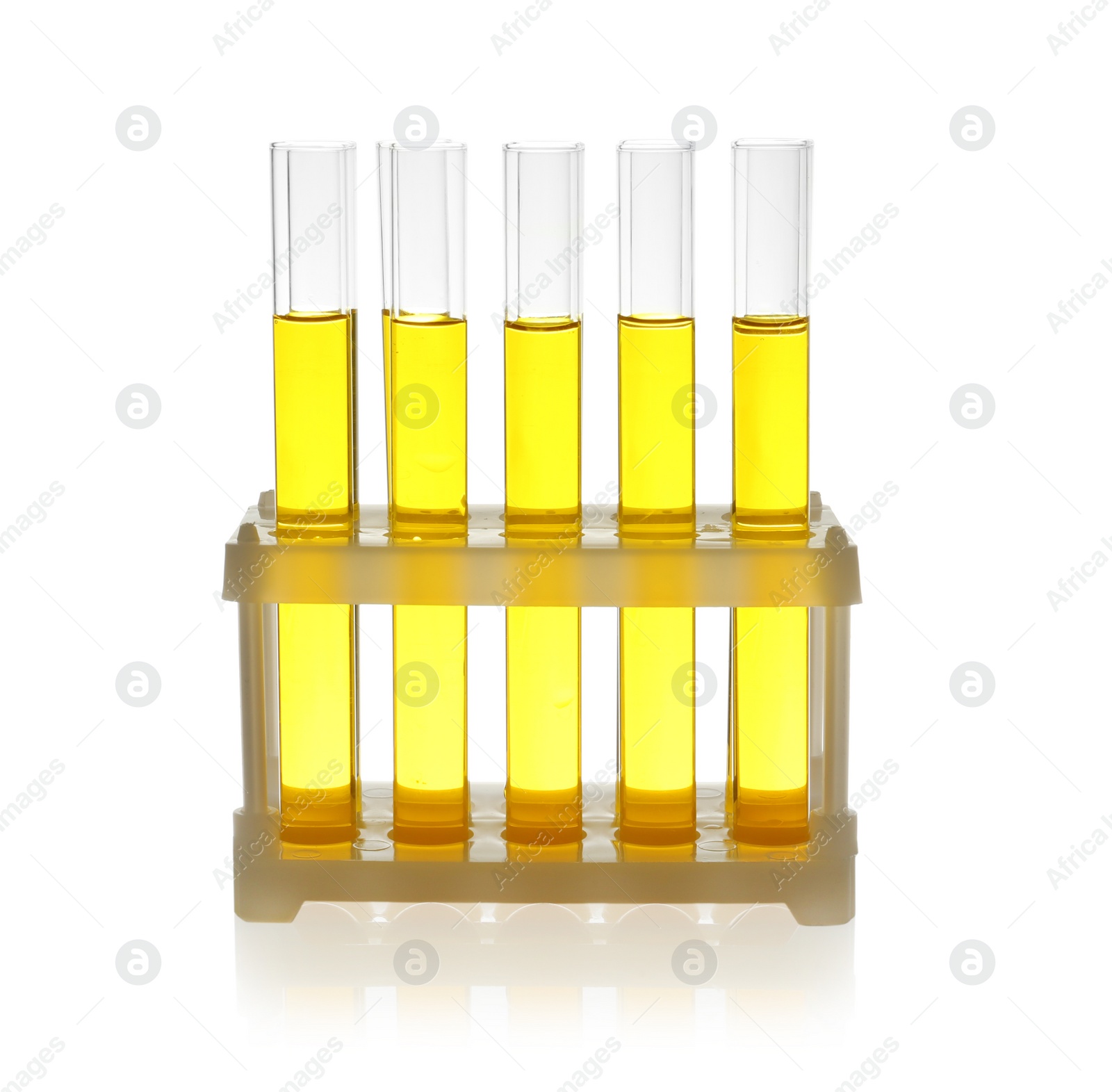 Photo of Test tubes with yellow liquid on white background