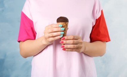 Photo of Woman holding yummy ice cream, closeup. Focus on hands