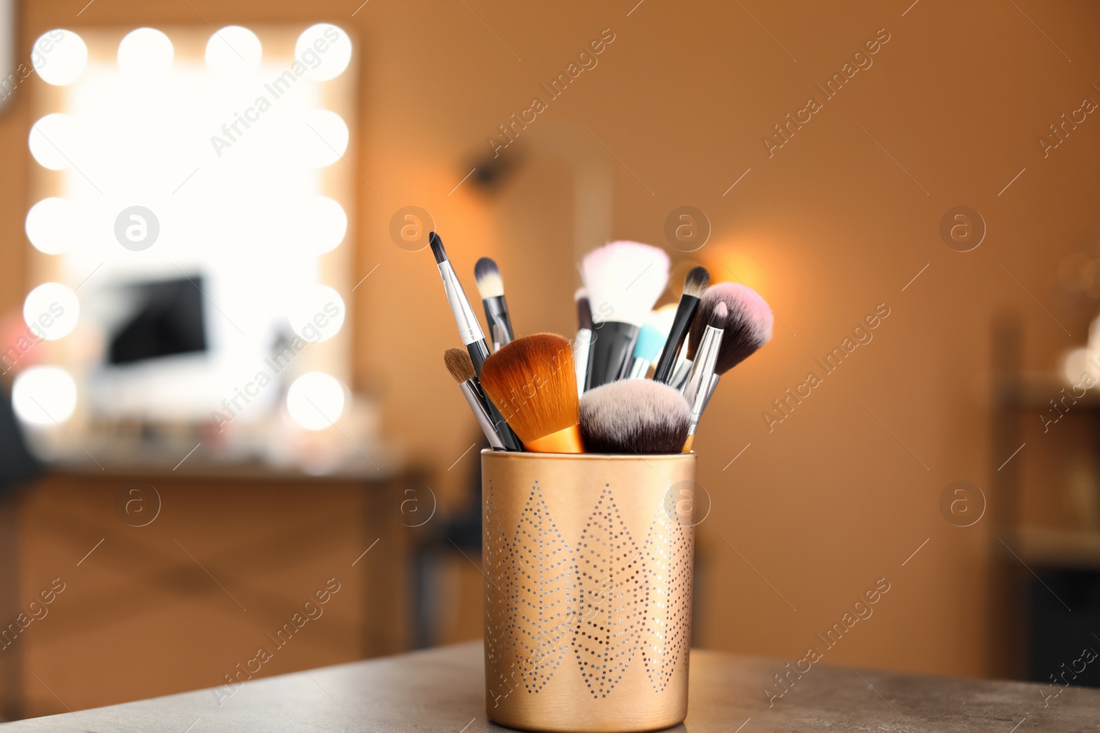 Photo of Holder with makeup brushes on table