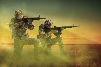 Image of Soldiers with machine guns on battlefield. War conflict