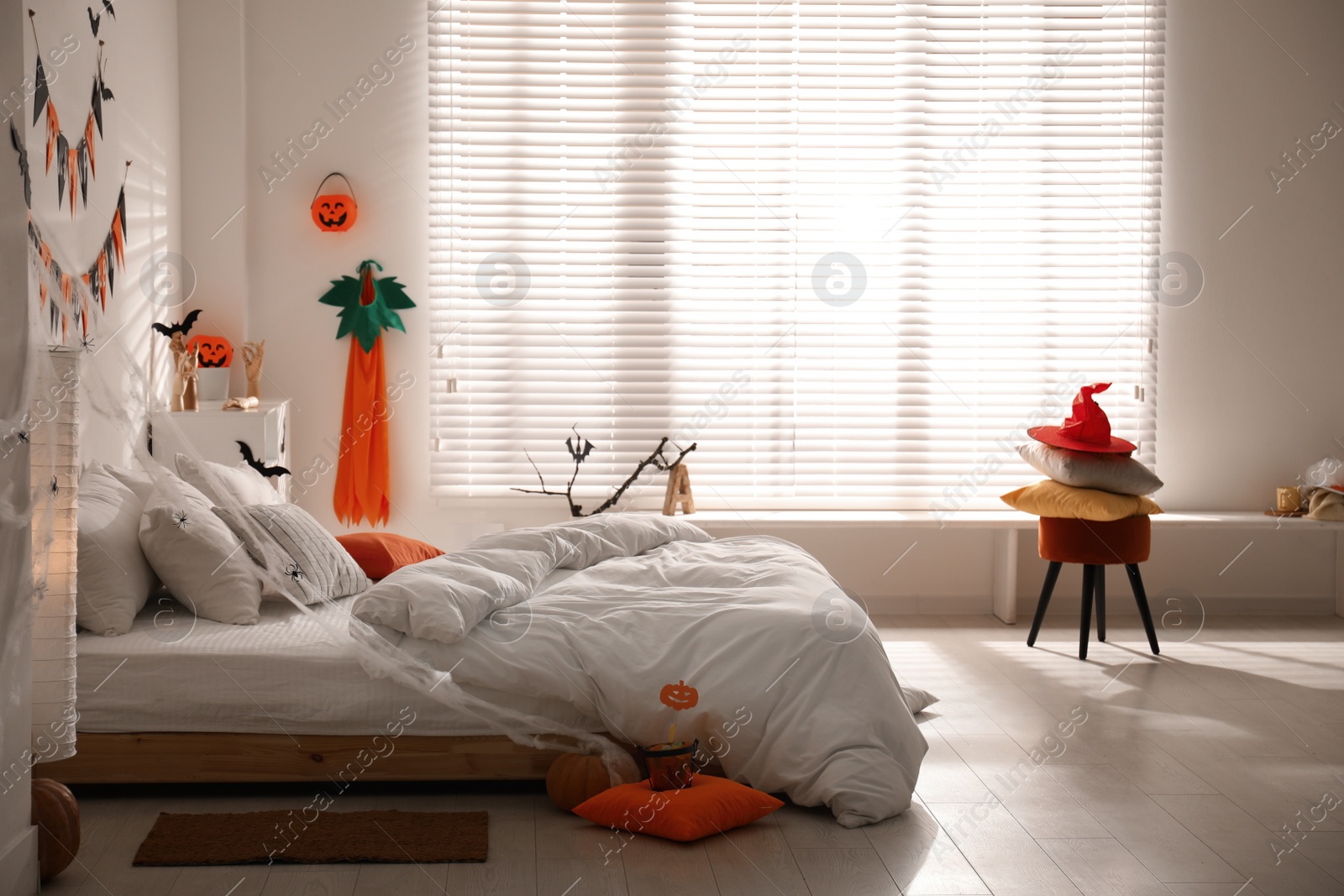 Photo of Stylish bedroom interior with festive Halloween decor