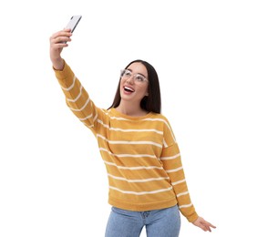 Smiling young woman taking selfie with smartphone on white background