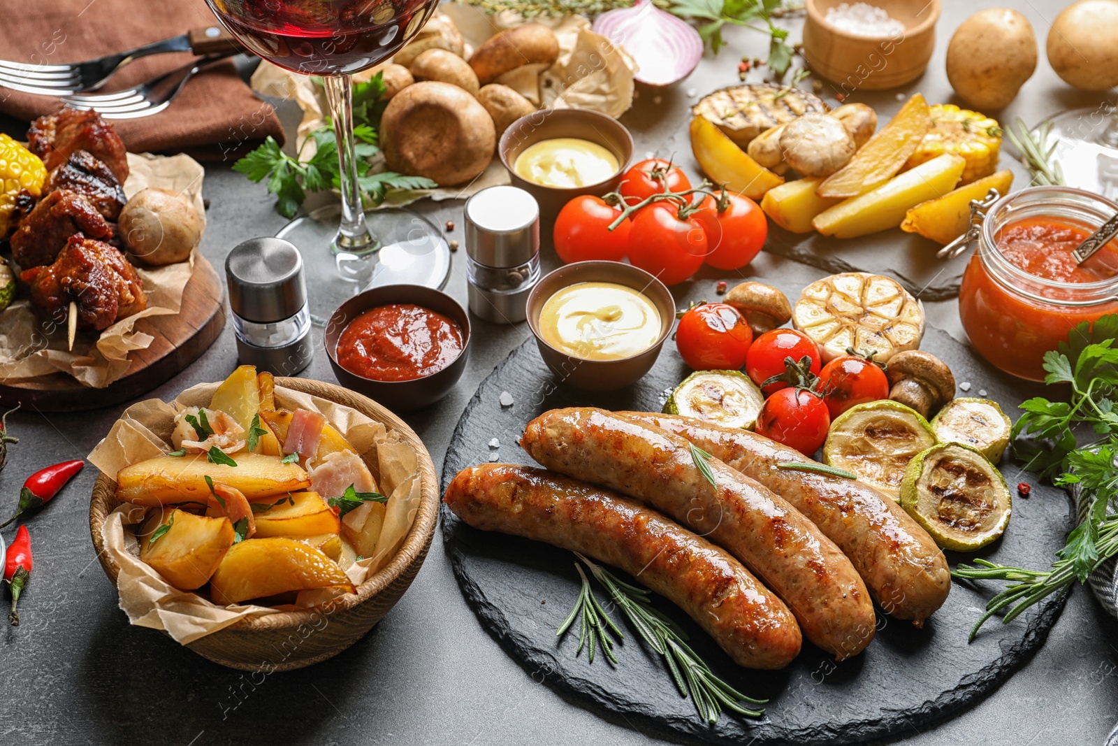 Photo of Delicious meal served for barbecue party on gray table