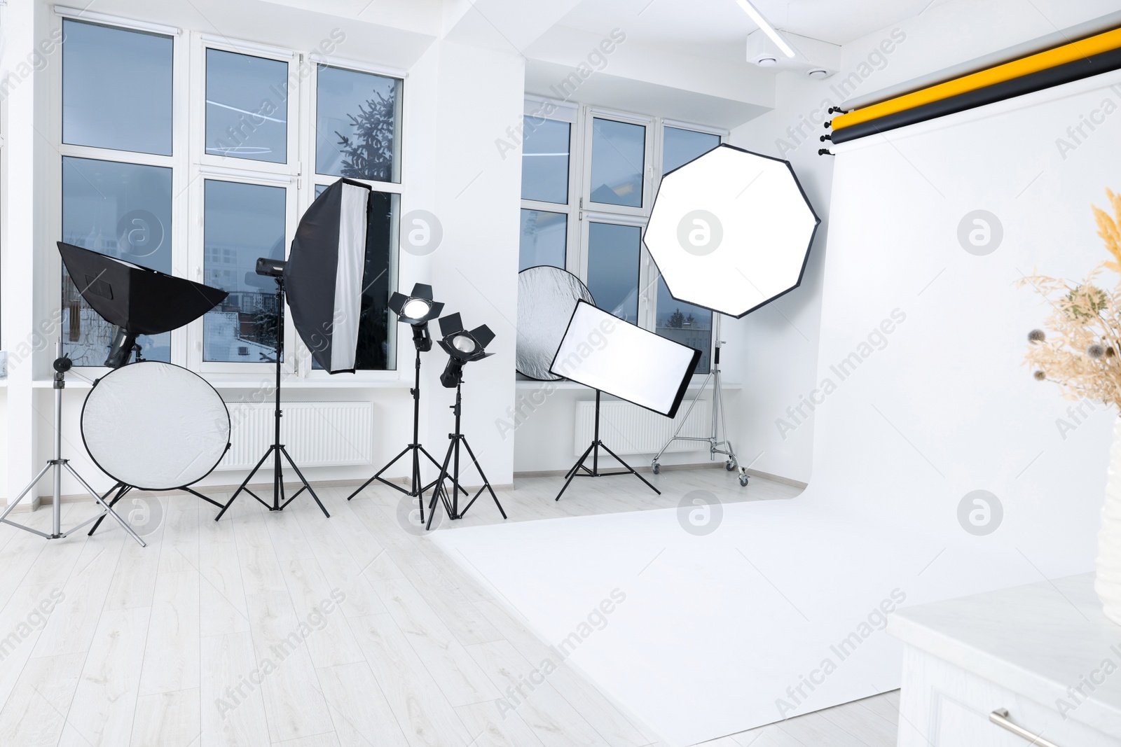 Photo of Interior of modern photo studio with professional lighting equipment