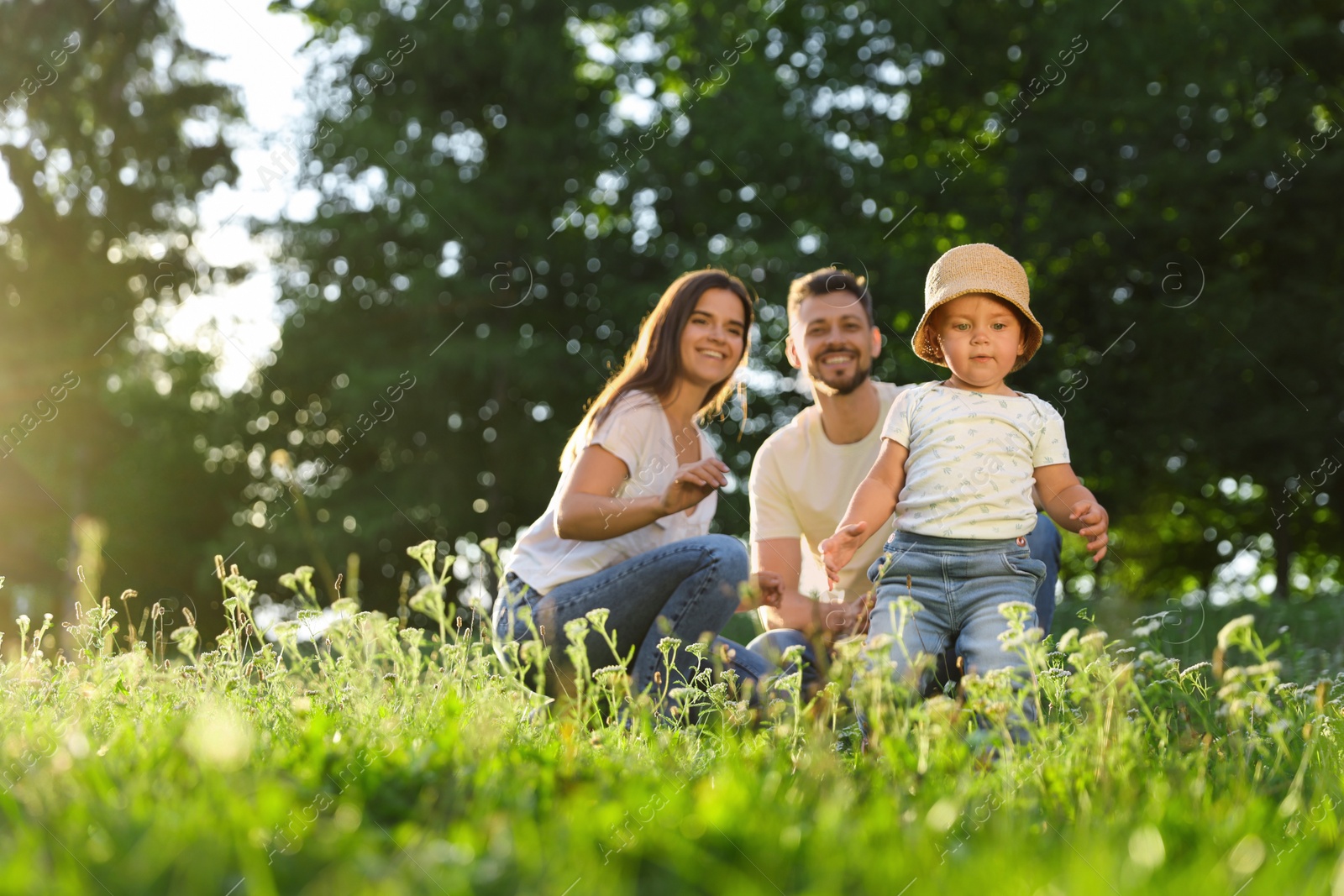 Photo of Happy cute family playing in park on sunny day