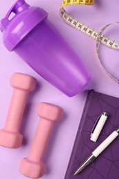 Photo of Flat lay composition with dumbbells on violet background