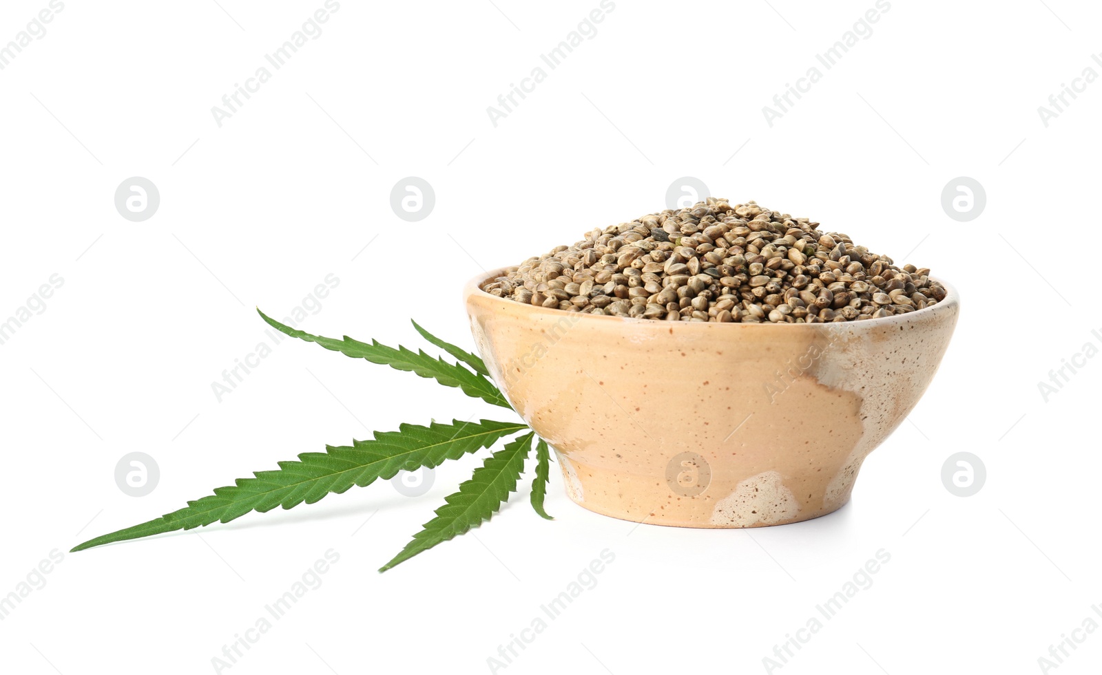 Photo of Bowl of hemp seeds with green leaf on white background