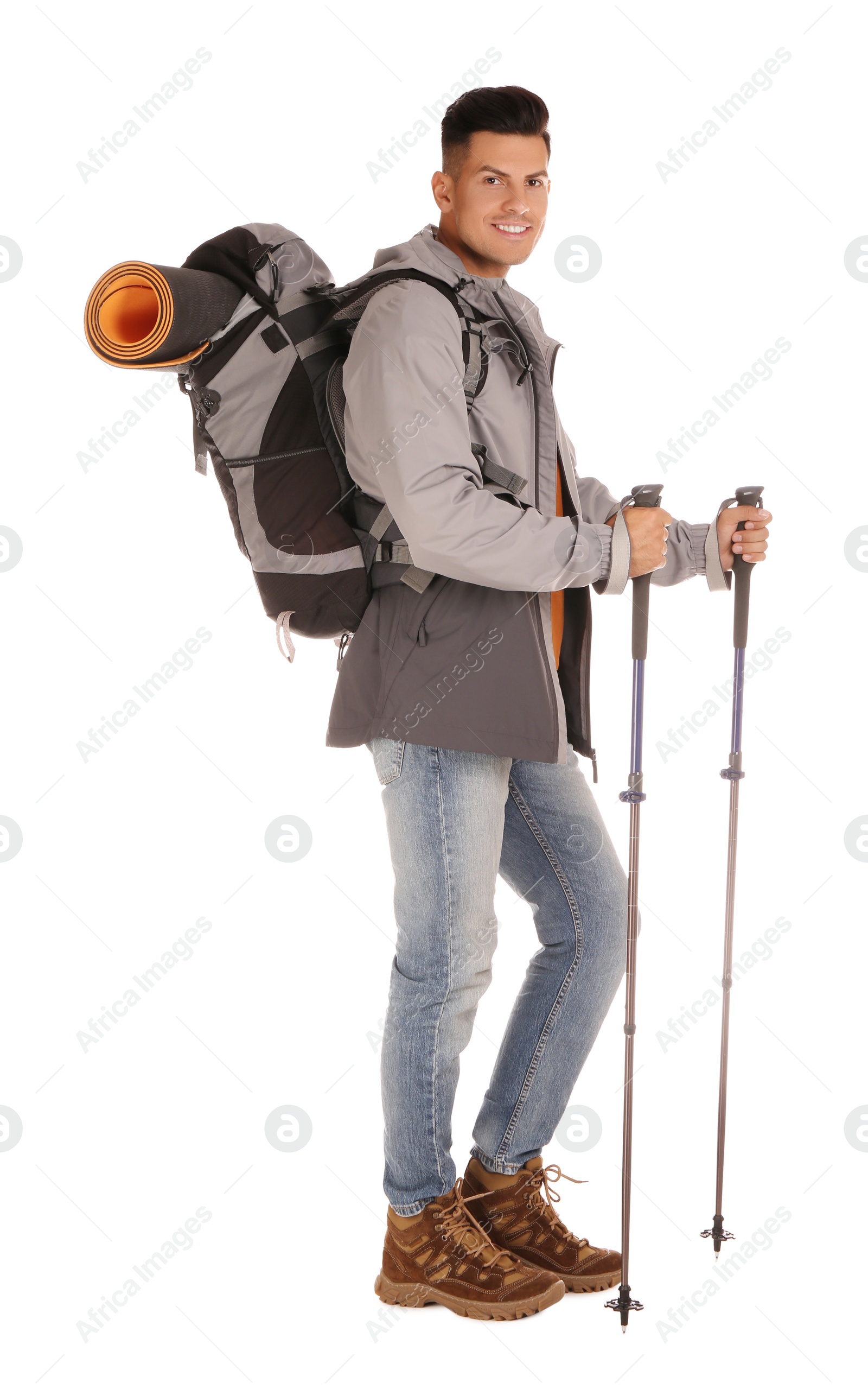 Photo of Male hiker with backpack and trekking poles on white background