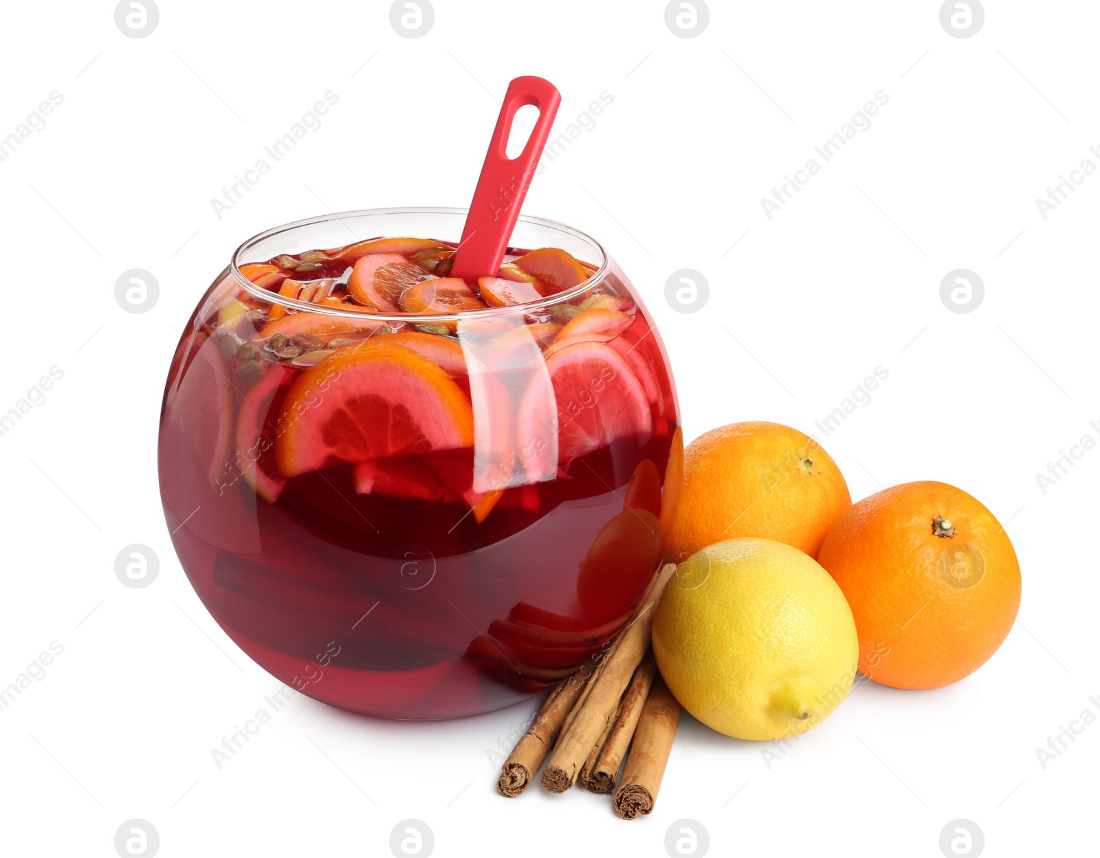 Photo of Glass bowl of aromatic punch drink and ingredients isolated on white