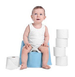 Little child sitting on baby potty and stack of toilet paper rolls against white background