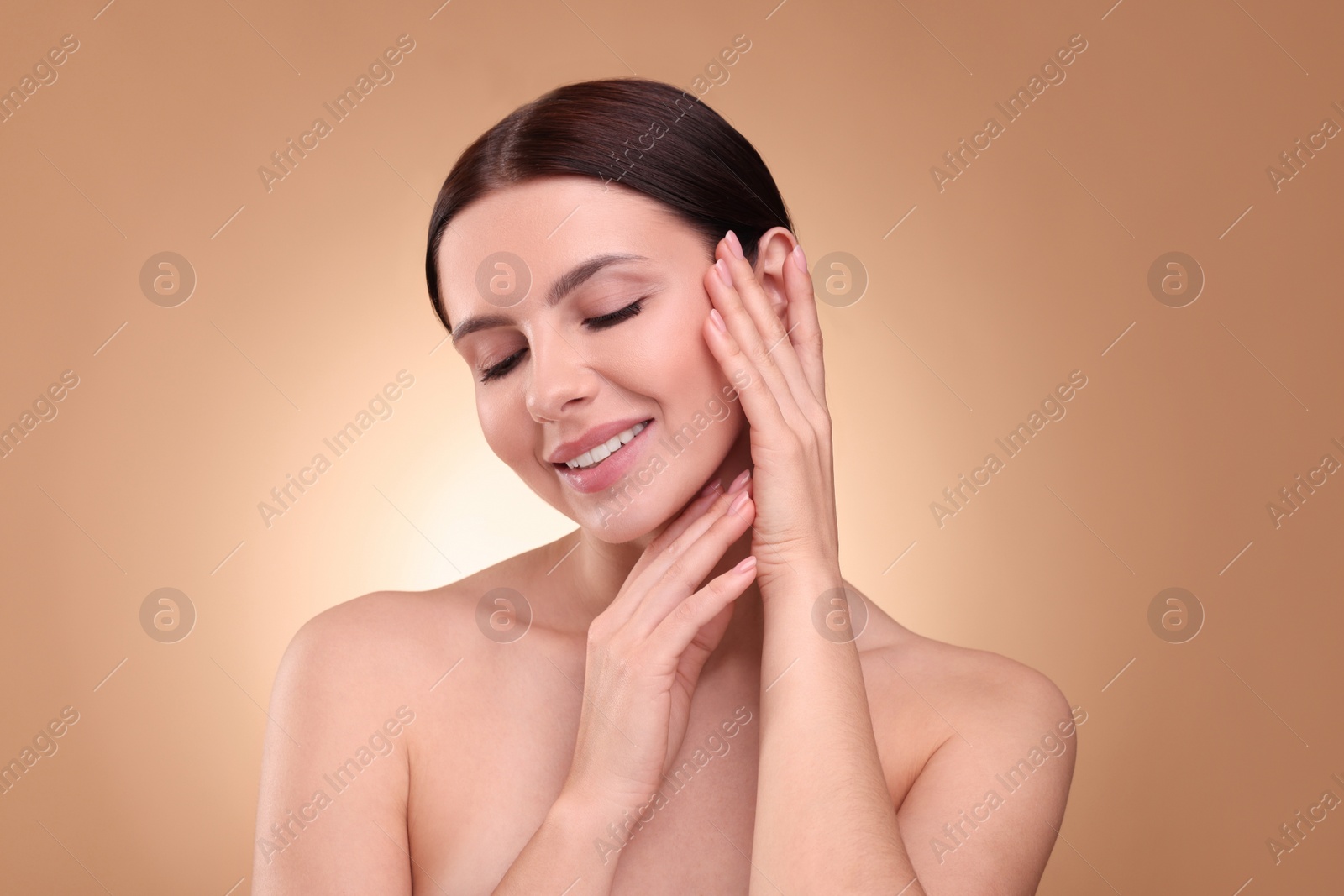 Photo of Beautiful woman with healthy skin on light brown background. Body Care