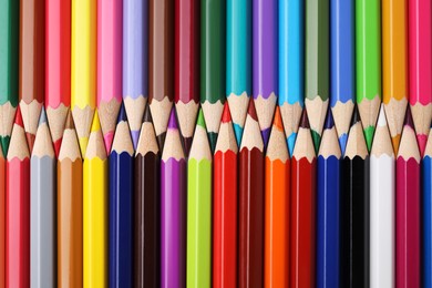 Many colorful wooden pencils as background, top view