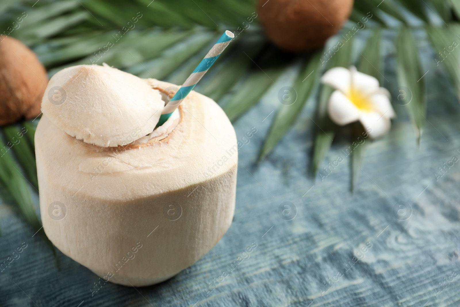 Photo of Fresh coconut drink in nut on wooden background