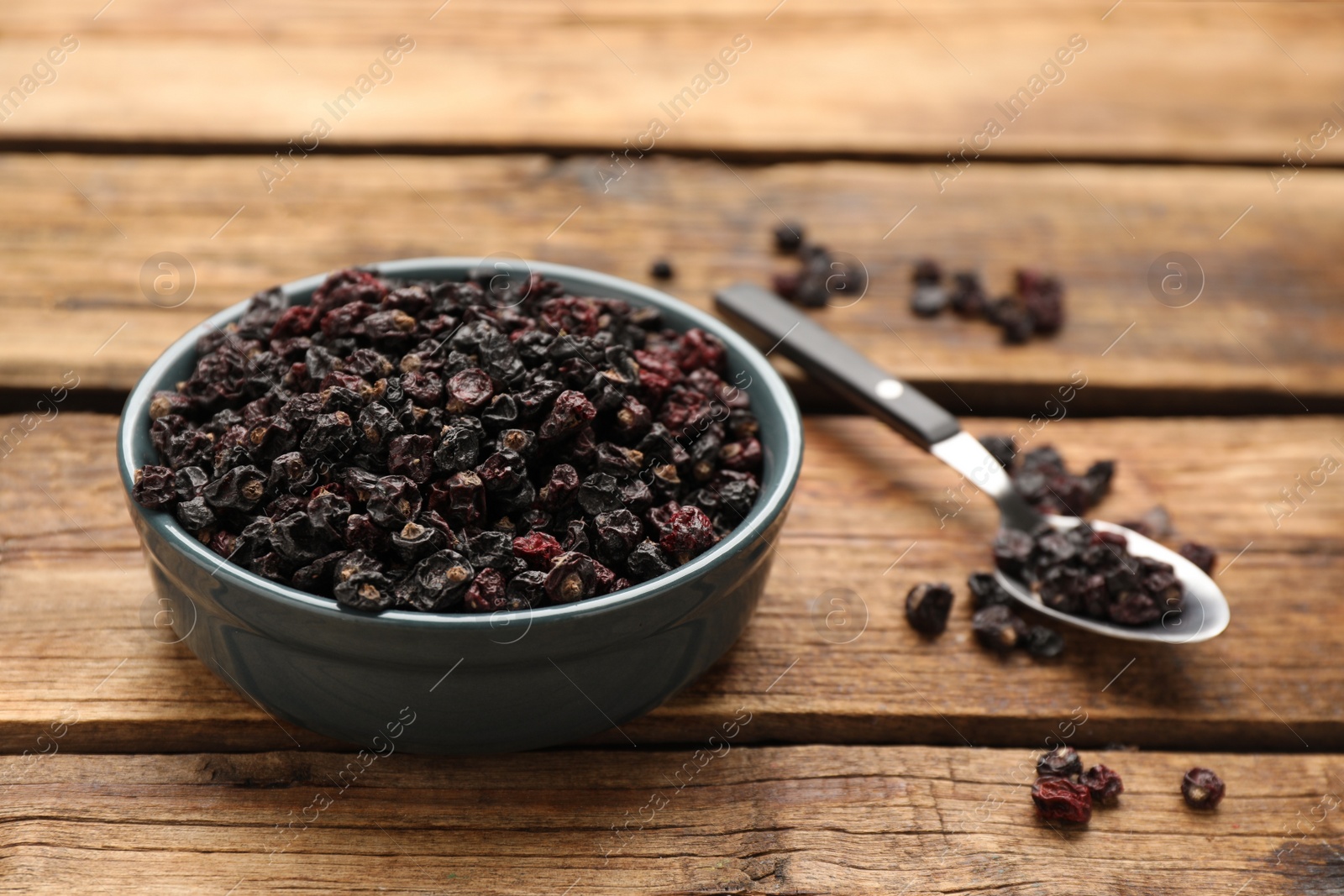 Photo of Dried black currant berries on wooden table
