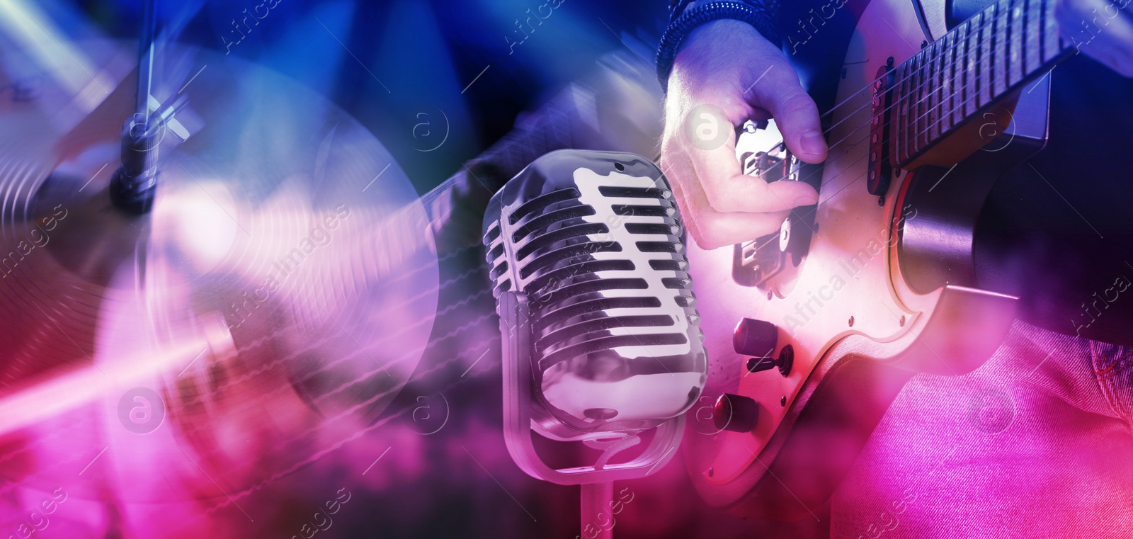 Image of Creative banner design. Vintage microphone and man playing electric guitar, closeup