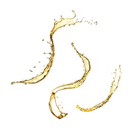 Image of Splashes of golden oily liquid on white background