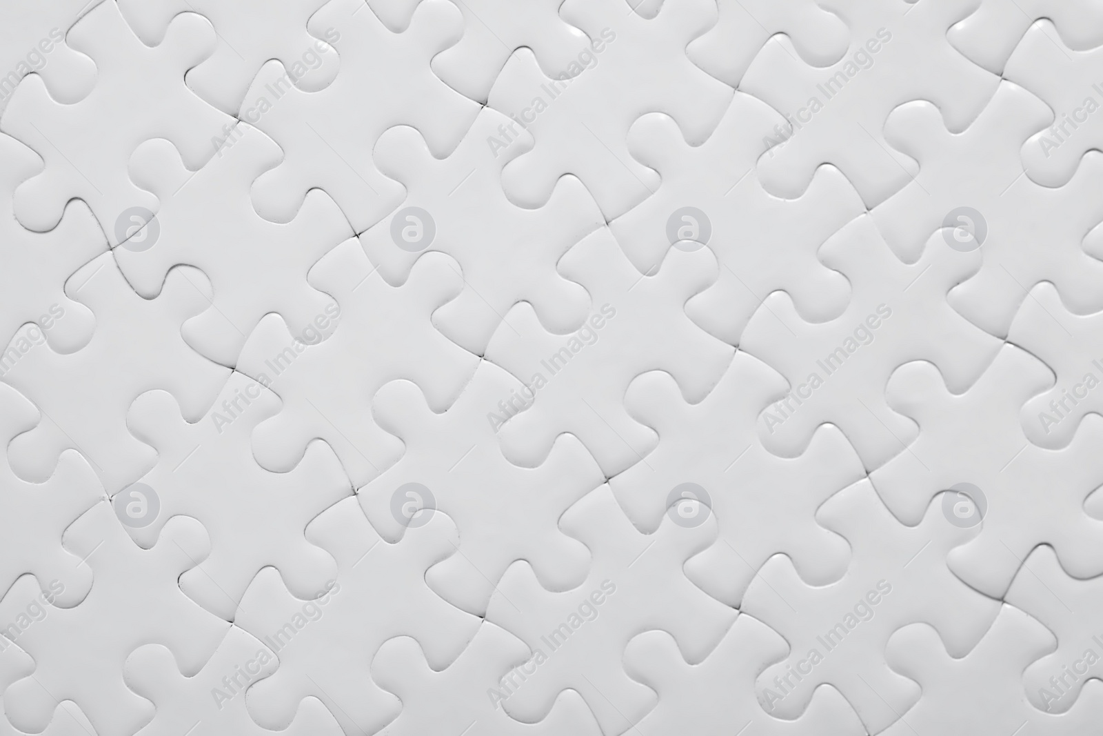 Photo of Blank white puzzle as background, top view