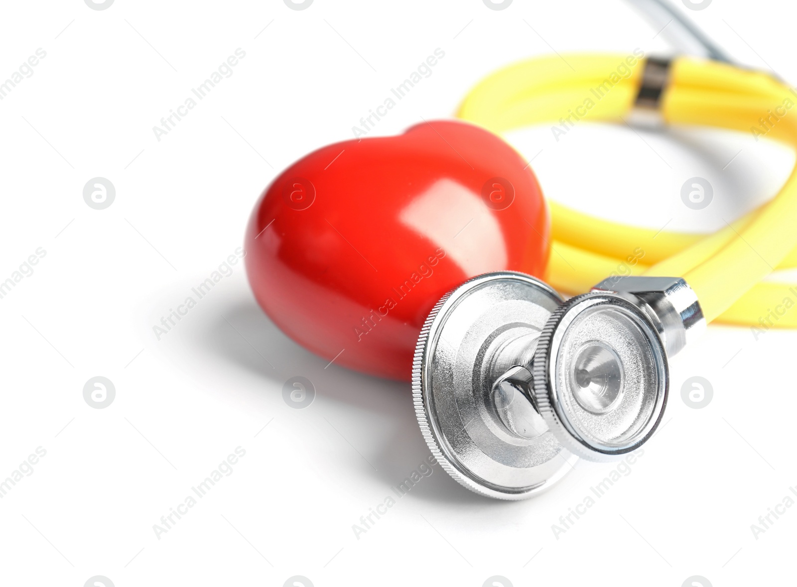 Photo of Stethoscope and heart model on light background, closeup. Medical equipment