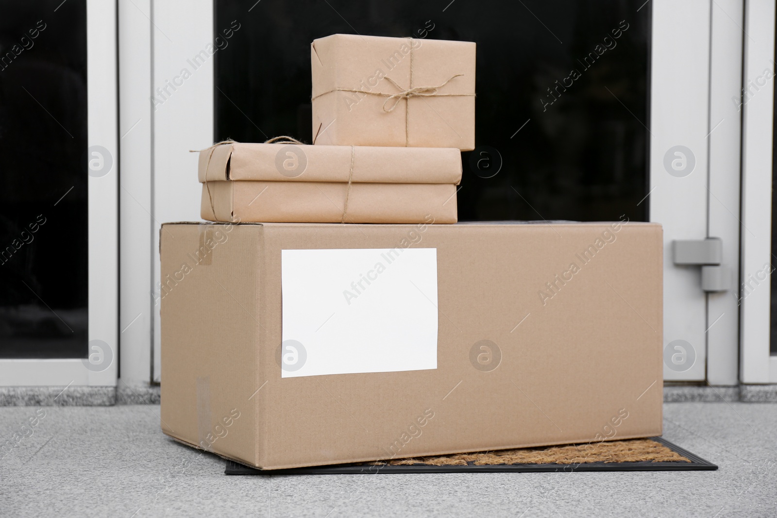 Photo of Delivered parcels on door mat near entrance