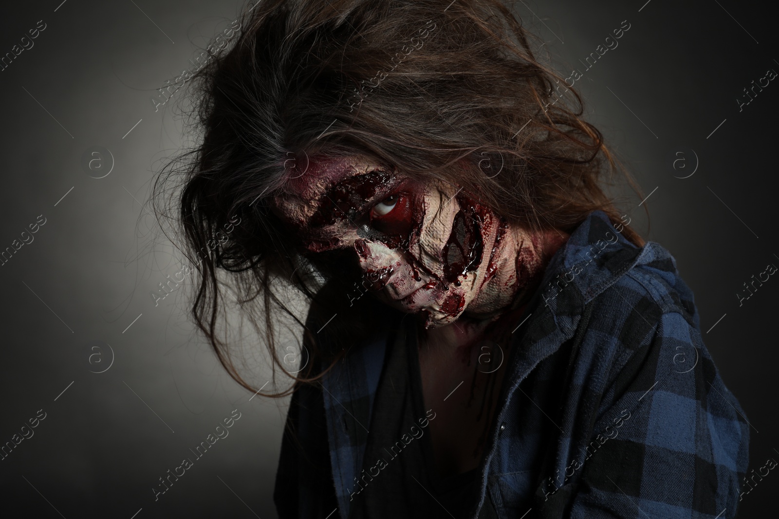 Photo of Scary zombie on dark background. Halloween monster