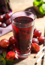 Photo of Delicious grape soda water on table. Refreshing drink